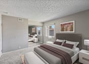 Thumbnail 10 of 24 - A bedroom with a large bed and a painting on the wall.