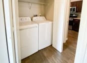 Thumbnail 9 of 54 - Utility room view with washer and dryer and shelving above