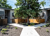 Thumbnail 24 of 24 - View of courtyard with sidewalk leading to buildings showcasing shaded private patio/balcony