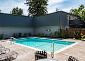 Thumbnail 13 of 24 - View of gated community pool with lounge chairs and seating