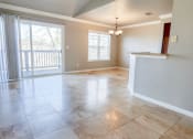 Thumbnail 11 of 54 - View of kitchen and dining area from living area, tile flooring, private patio/balcony access, well lit window
