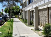 Thumbnail 1 of 11 - an empty sidewalk in front of an apartment building