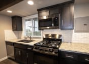 Thumbnail 4 of 18 - Kitchen with granite counters and stainless appliances and double sink