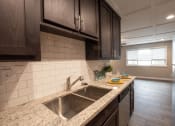 Thumbnail 2 of 18 - Kitchen with granite counters and stainless appliance
