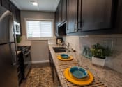 Thumbnail 3 of 18 - Kitchen with granite counters and stainless appliance