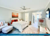 Thumbnail 15 of 23 - a bedroom with a bed and a ceiling fan