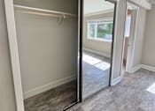 Thumbnail 12 of 28 - A room with a sliding glass door and a grey carpet.