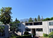 Thumbnail 1 of 16 - exterior building photo at Americana La Crescenta with mountain view behind