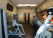 Thumbnail 33 of 54 - Community fitness center with stair stepper, and weight machine.