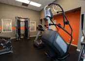Thumbnail 32 of 54 - Fitness center at Lake Forest with stair stepper and weight machine