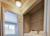 Thumbnail 7 of 54 - Utility room with washer and dryer and shelving above