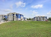 Thumbnail 36 of 48 - A Large Grassy Area at Midtown Sam Houston Apartments, Texas, 77340