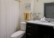 Thumbnail 23 of 48 - A Bathroom With Shower Curtain at Midtown Sam Houston Apartments, Texas, 77340