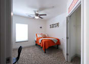 Thumbnail 12 of 48 - Bedroom with Ceiling Fan at Midtown Sam Houston Apartments, Huntsville, TX, 77340