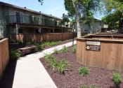 Thumbnail 15 of 34 - View of sidewalk winding through property showcasing private patio/balcony and nice landscaping