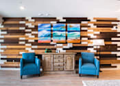 Thumbnail 9 of 65 - a lobby with two blue chairs and a wall with three paintings on it  at Parks Residential - Richardson, Texas, 75082