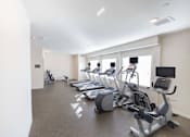 Thumbnail 7 of 65 - the gym has cardio equipment and treadmills in it at Parks Residential - Richardson, Richardson, 75082