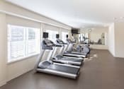 Thumbnail 6 of 65 - a row of treadmills in a fitness room at Parks Residential - Richardson, Richardson, Texas