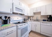 Thumbnail 13 of 65 - a kitchen with pink and purple lights at Parks Residential - Richardson, Texas