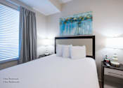 Thumbnail 20 of 65 - a bedroom with a large bed and a window at Parks Residential - Richardson, Texas