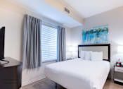 Thumbnail 15 of 65 - a bedroom with a large white bed and a window at Parks Residential - Richardson, Texas, 75082