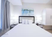 Thumbnail 23 of 65 - a bedroom with a large white bed and white cabinets at Parks Residential - Richardson, Richardson, Texas