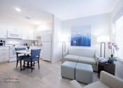 Thumbnail 18 of 65 - a living room with a couch and a table at Parks Residential - Richardson, Texas