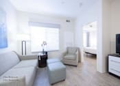 Thumbnail 14 of 65 - a living room with a couch and a chair and a tv at Parks Residential - Richardson, Richardson