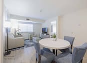 Thumbnail 25 of 65 - a living room with a white table and chairs at Parks Residential - Richardson, Texas
