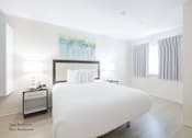 Thumbnail 41 of 65 - a bedroom with a large white bed and two nightstands at Parks Residential - Richardson, Texas, 75082