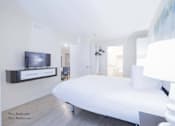 Thumbnail 37 of 65 - a bedroom with a large bed and a tv at Parks Residential - Richardson, Richardson, Texas