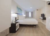 Thumbnail 42 of 65 - a bedroom with a bed and a tv in a hotel room at Parks Residential - Richardson, Richardson, 75082