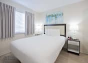 Thumbnail 34 of 65 - a bedroom with a large white bed and a window at Parks Residential - Richardson, Texas, 75082