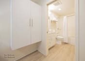 Thumbnail 43 of 65 - a bathroom with white cabinets and a toilet and a sink at Parks Residential - Richardson, Richardson, Texas