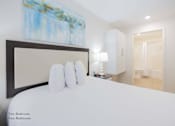 Thumbnail 38 of 65 - a bedroom with a large white bed and a painting on the wall at Parks Residential - Richardson, Texas, 75082