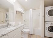 Thumbnail 44 of 65 - a bathroom with a washing machine and a toilet and a washer and dryer at Parks Residential - Richardson, Texas, 75082