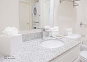 Thumbnail 36 of 65 - a white bathroom with a sink and a mirror at Parks Residential - Richardson, Texas