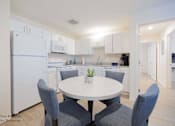 Thumbnail 48 of 65 - a kitchen with white cabinets and a white table and chairs at Parks Residential - Richardson, Richardson, TX, 75082