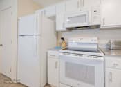 Thumbnail 50 of 65 - a kitchen with white appliances and white cabinets at Parks Residential - Richardson, Richardson, TX, 75082