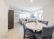 Thumbnail 47 of 65 - a living room and dining room with a white table and chairs at Parks Residential - Richardson, Texas, 75082