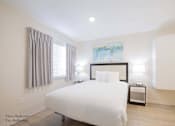 Thumbnail 61 of 65 - a white bedroom with a large white bed and white cabinets at Parks Residential - Richardson, Richardson, 75082