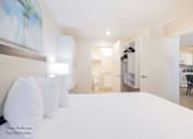 Thumbnail 63 of 65 - a bedroom with a bed and a closet and a bathroom at Parks Residential - Richardson, Texas, 75082