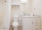 Thumbnail 64 of 65 - a bathroom with a toilet and a sink and a mirror at Parks Residential - Richardson, Texas, 75082