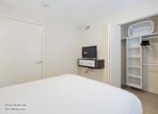 Thumbnail 62 of 65 - a bedroom with a bed and a closet and a television at Parks Residential - Richardson, Richardson, 75082