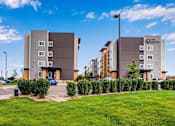 Thumbnail 3 of 12 - an exterior view of an apartment building with a parking lot at Parks Residential - Denver, Centennial, CO