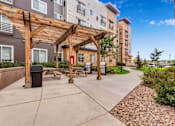 Thumbnail 5 of 12 - our apartments have a spacious patio with a wood pavilion and picnic tables at Parks Residential - Denver, Colorado