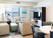 Thumbnail 8 of 12 - a living room with chairs and a table and a television at Parks Residential - Denver, Centennial, 80111
