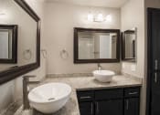 Thumbnail 8 of 16 - View of bathroom vanity with two vessel sinks and two mirrors with lighting