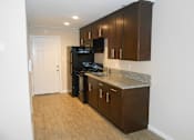 Thumbnail 6 of 11 - a kitchen with a black stove and a refrigerator at Park Place, Turlock, CA, 95382