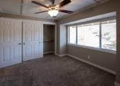 Thumbnail 21 of 27 - View of bedroom with carpet flooring, sliding door access to closet, ceiling fan, and well lit window